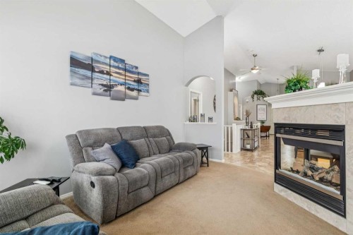 328 Cove Road, Chestermere, AB - Indoor Photo Showing Living Room With Fireplace
