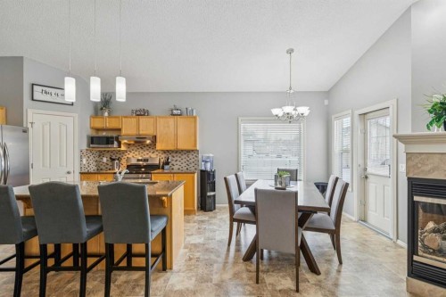 328 Cove Road, Chestermere, AB - Indoor Photo Showing Dining Room With Fireplace