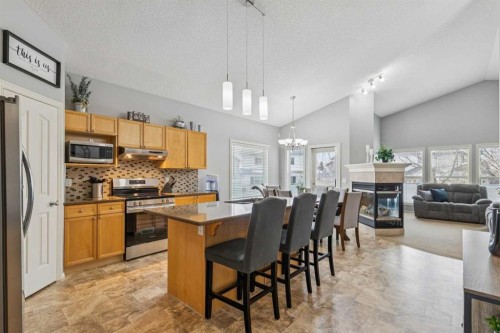 328 Cove Road, Chestermere, AB - Indoor Photo Showing Other Room With Fireplace