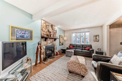 8 Meadow Place Se, Airdrie, AB - Indoor Photo Showing Living Room With Fireplace