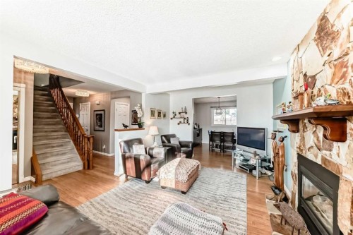 8 Meadow Place Se, Airdrie, AB - Indoor Photo Showing Living Room With Fireplace