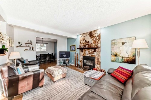 8 Meadow Place Se, Airdrie, AB - Indoor Photo Showing Living Room With Fireplace