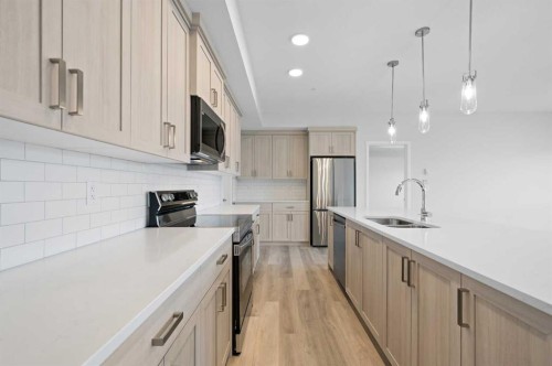 3205-220 Seton Grove Se, Calgary, AB - Indoor Photo Showing Kitchen With Stainless Steel Kitchen With Double Sink With Upgraded Kitchen