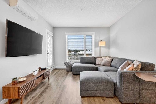 401-150 Shawnee Square Sw, Calgary, AB - Indoor Photo Showing Living Room