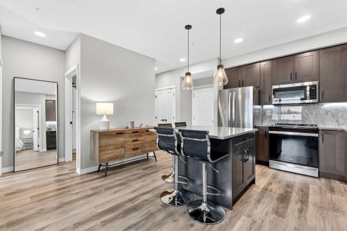 401-150 Shawnee Square Sw, Calgary, AB - Indoor Photo Showing Kitchen With Upgraded Kitchen