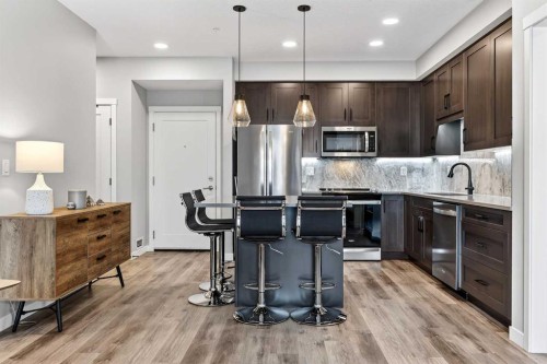 401-150 Shawnee Square Sw, Calgary, AB - Indoor Photo Showing Kitchen With Upgraded Kitchen