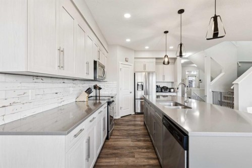 57 Crestridge Bay Sw, Calgary, AB - Indoor Photo Showing Kitchen With Stainless Steel Kitchen With Double Sink With Upgraded Kitchen
