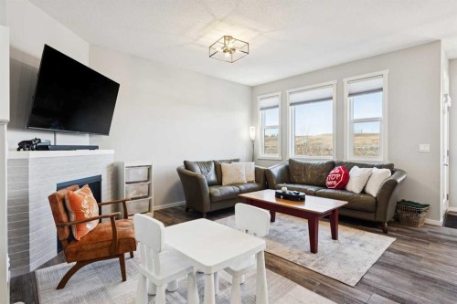 57 Crestridge Bay Sw, Calgary, AB - Indoor Photo Showing Living Room With Fireplace