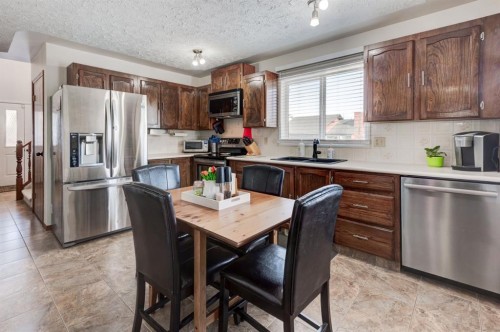 4 Cedargrove Way Sw, Calgary, AB - Indoor Photo Showing Kitchen With Stainless Steel Kitchen With Double Sink