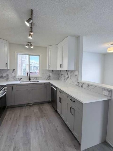 42 Somerside Place Sw, Calgary, AB - Indoor Photo Showing Kitchen With Double Sink