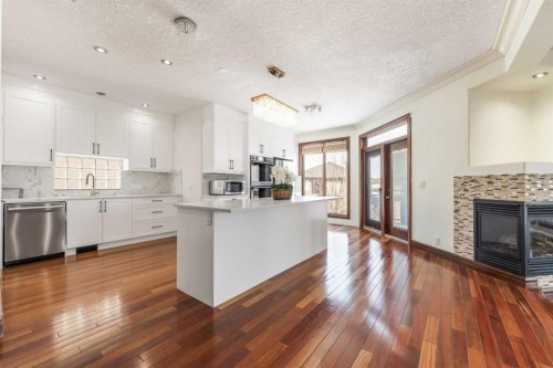 8 Coulee Park Sw, Calgary, AB - Indoor Photo Showing Kitchen With Fireplace With Upgraded Kitchen