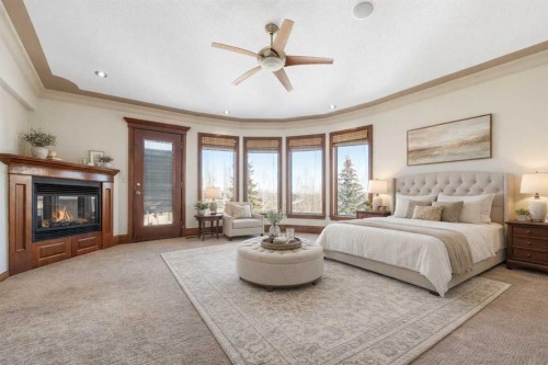 8 Coulee Park Sw, Calgary, AB - Indoor Photo Showing Bedroom With Fireplace
