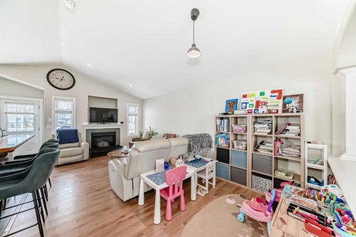 172 Sunset Heights, Crossfield, AB - Indoor Photo Showing Other Room With Fireplace