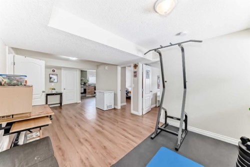 172 Sunset Heights, Crossfield, AB - Indoor Photo Showing Gym Room