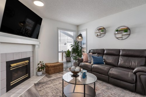 303 Coventry Close Ne, Calgary, AB - Indoor Photo Showing Living Room With Fireplace