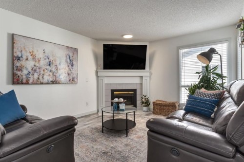 303 Coventry Close Ne, Calgary, AB - Indoor Photo Showing Living Room With Fireplace