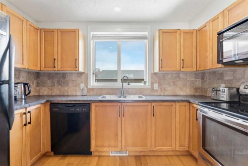 66 Auburn Bay Crescent Se, Calgary, AB - Indoor Photo Showing Kitchen With Double Sink