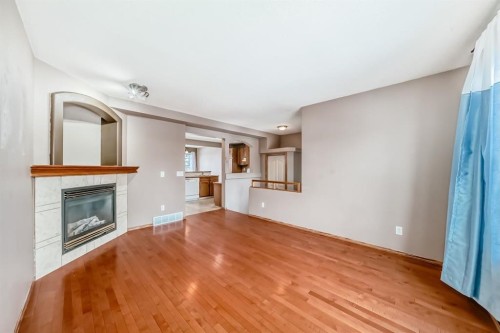 11 Coventry Link Ne, Calgary, AB - Indoor Photo Showing Living Room With Fireplace