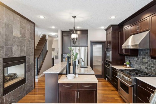 25 Mahogany Square Se, Calgary, AB - Indoor Photo Showing Kitchen With Fireplace With Upgraded Kitchen