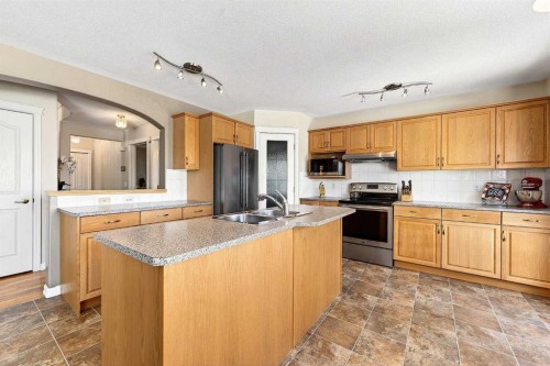219 Hidden Ranch Circle Nw, Calgary, AB - Indoor Photo Showing Kitchen With Double Sink