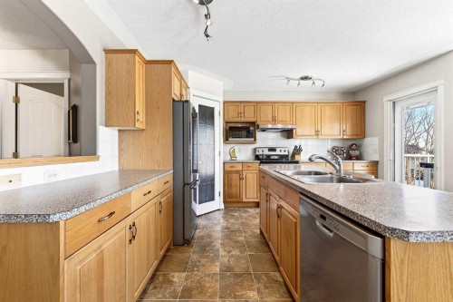 219 Hidden Ranch Circle Nw, Calgary, AB - Indoor Photo Showing Kitchen With Double Sink