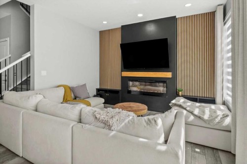 243 Silver Spruce Grove Sw, Calgary, AB - Indoor Photo Showing Living Room With Fireplace