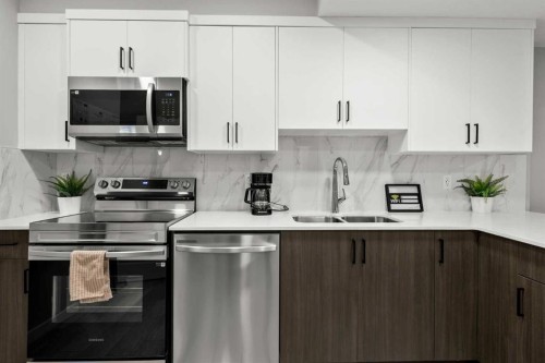 243 Silver Spruce Grove Sw, Calgary, AB - Indoor Photo Showing Kitchen With Double Sink With Upgraded Kitchen