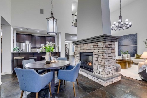 151 Mahogany Bay Se, Calgary, AB - Indoor Photo Showing Dining Room With Fireplace