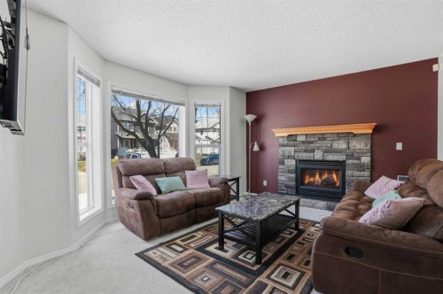 155 Tarington Green Ne, Calgary, AB - Indoor Photo Showing Living Room With Fireplace