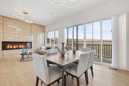 230 Royal Birch View Nw, Calgary, AB - Indoor Photo Showing Dining Room With Fireplace