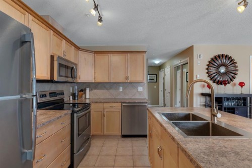 2117-303 Arbour Crest Drive Nw, Calgary, AB - Indoor Photo Showing Kitchen With Stainless Steel Kitchen With Double Sink
