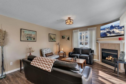 2117-303 Arbour Crest Drive Nw, Calgary, AB - Indoor Photo Showing Living Room With Fireplace