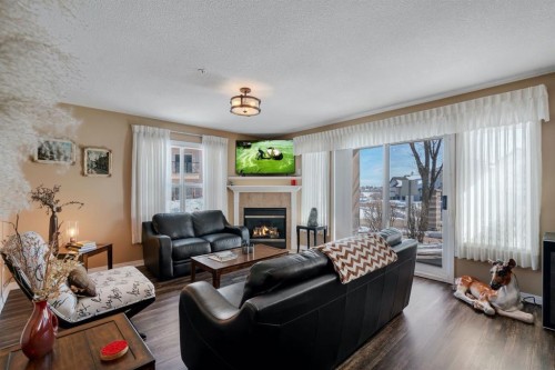 2117-303 Arbour Crest Drive Nw, Calgary, AB - Indoor Photo Showing Living Room With Fireplace