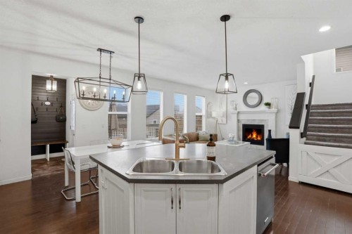 119 Prestwick Terrace Se, Calgary, AB - Indoor Photo Showing Kitchen With Fireplace With Double Sink