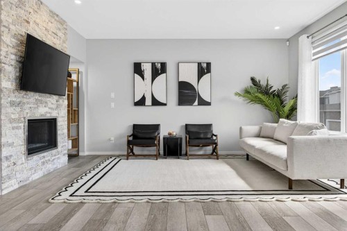 73 Yorkstone Heath Sw, Calgary, AB - Indoor Photo Showing Living Room With Fireplace