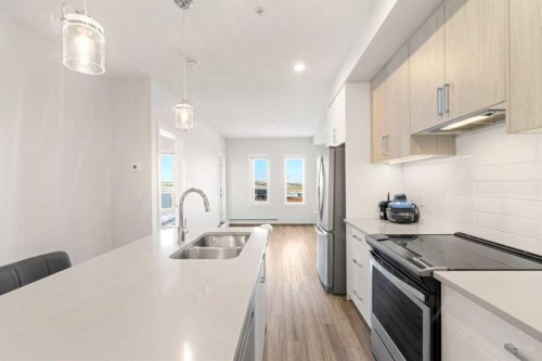 208-138 Sage Valley Common Nw, Calgary, AB - Indoor Photo Showing Kitchen With Stainless Steel Kitchen With Double Sink With Upgraded Kitchen