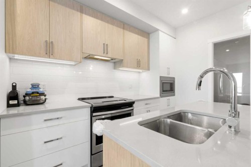 208-138 Sage Valley Common Nw, Calgary, AB - Indoor Photo Showing Kitchen With Double Sink With Upgraded Kitchen