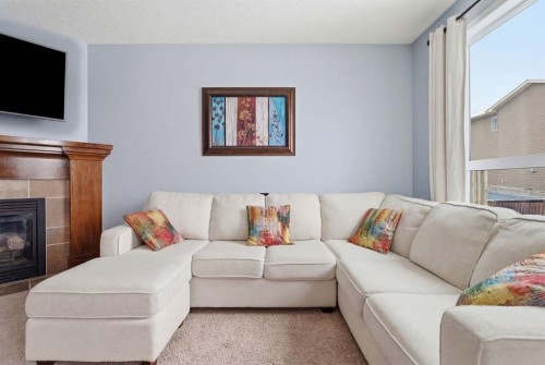 512 Panatella Square Nw, Calgary, AB - Indoor Photo Showing Living Room With Fireplace