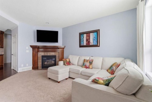512 Panatella Square Nw, Calgary, AB - Indoor Photo Showing Living Room With Fireplace