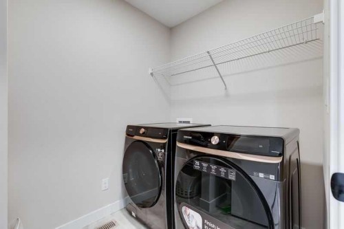 100 Langwell Common Se, Airdrie, AB - Indoor Photo Showing Laundry Room