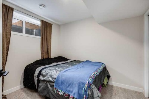 100 Langwell Common Se, Airdrie, AB - Indoor Photo Showing Bedroom