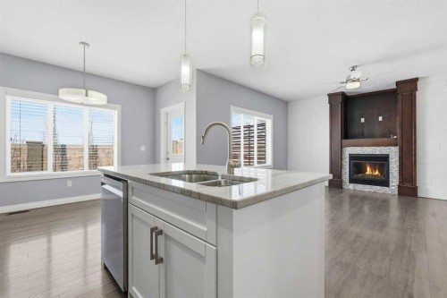 196 Evansborough Way Nw, Calgary, AB - Indoor Photo Showing Kitchen With Fireplace With Double Sink