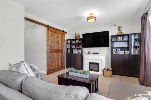 21 Masters Place Se, Calgary, AB - Indoor Photo Showing Living Room With Fireplace