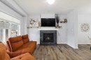 27 Masters Manor Se, Calgary, AB  - Indoor Photo Showing Living Room With Fireplace 
