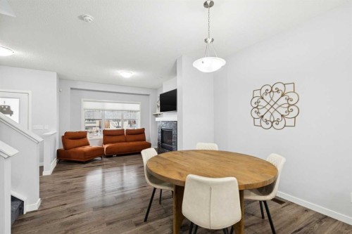 27 Masters Manor Se, Calgary, AB - Indoor Photo Showing Dining Room With Fireplace