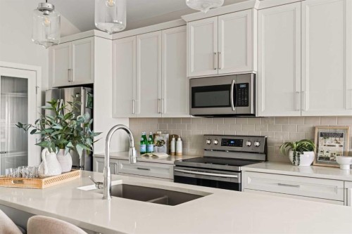 106-55 Fireside Circle, Cochrane, AB - Indoor Photo Showing Kitchen With Stainless Steel Kitchen With Double Sink With Upgraded Kitchen