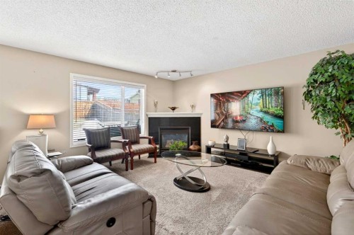 238 Royal Birch View Nw, Calgary, AB - Indoor Photo Showing Living Room With Fireplace