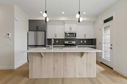 12 Waterford Glen, Chestermere, AB - Indoor Photo Showing Kitchen With Upgraded Kitchen