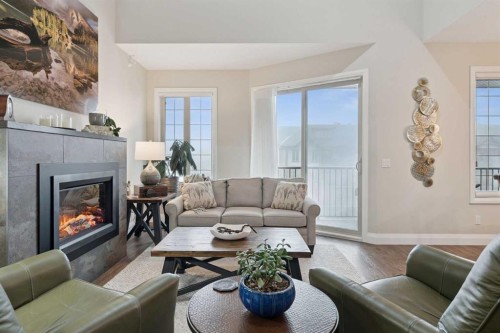 2410-15 Sunset Square, Cochrane, AB - Indoor Photo Showing Living Room With Fireplace