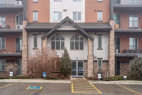 2410-15 Sunset Square, Cochrane, AB - Outdoor With Balcony With Facade